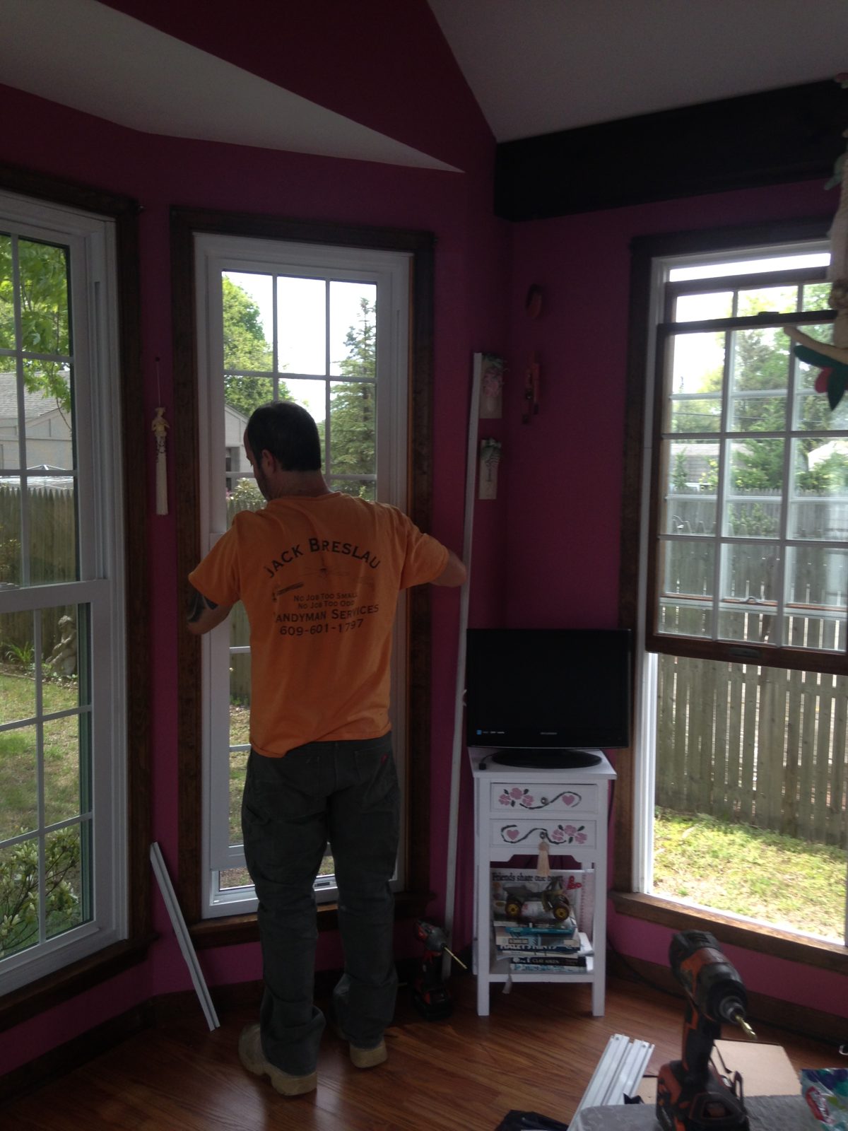 Jack installing a window in a sunroom