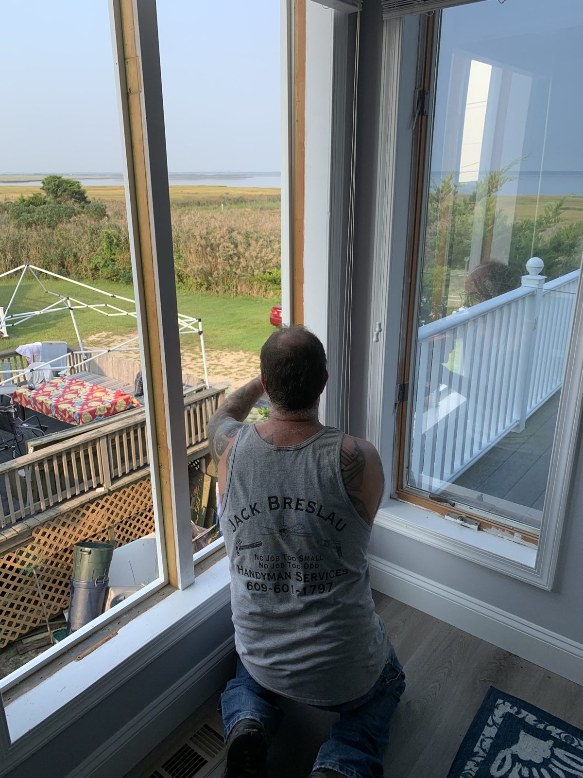 Jack servicing a window overlooking the bay